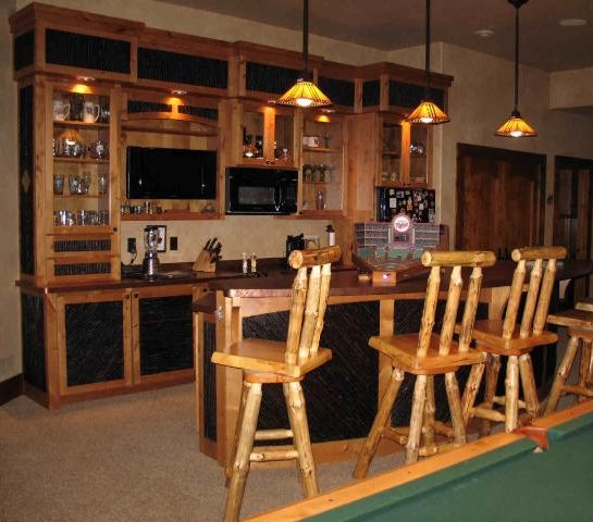 Pendant light fixtures over a bar area in a log home