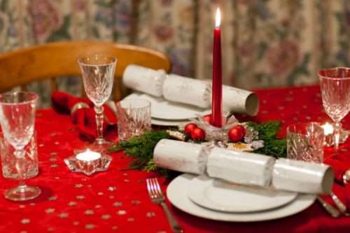 Red tablecloth with Christmas table settings