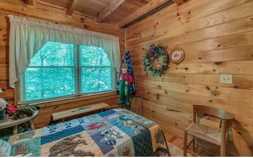 swag curtains in a log cabin bedroom