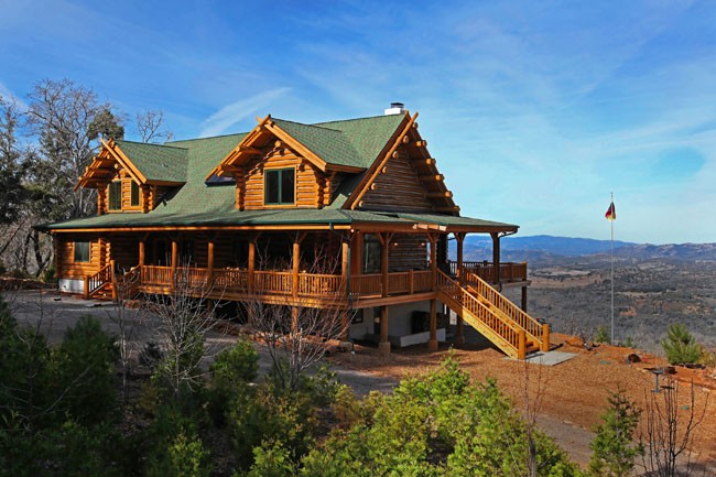 log home on a hill, with a beautiful view of a valley