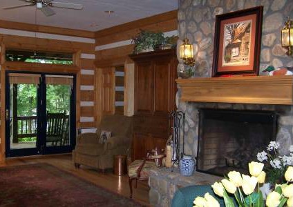 wall lighting with sconces beside a fireplace in a log home