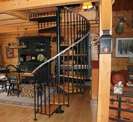 wrought iron circular stairs in a log home