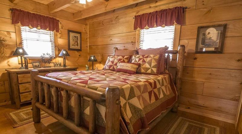 Valances on windows in log cabin bedroom