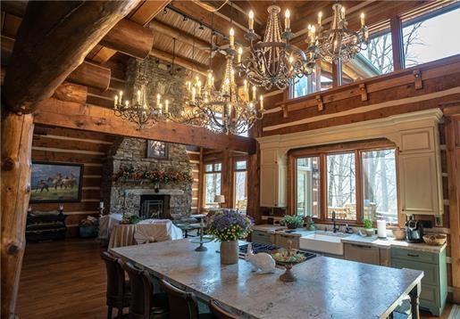 3 chandeliers in a log home living area