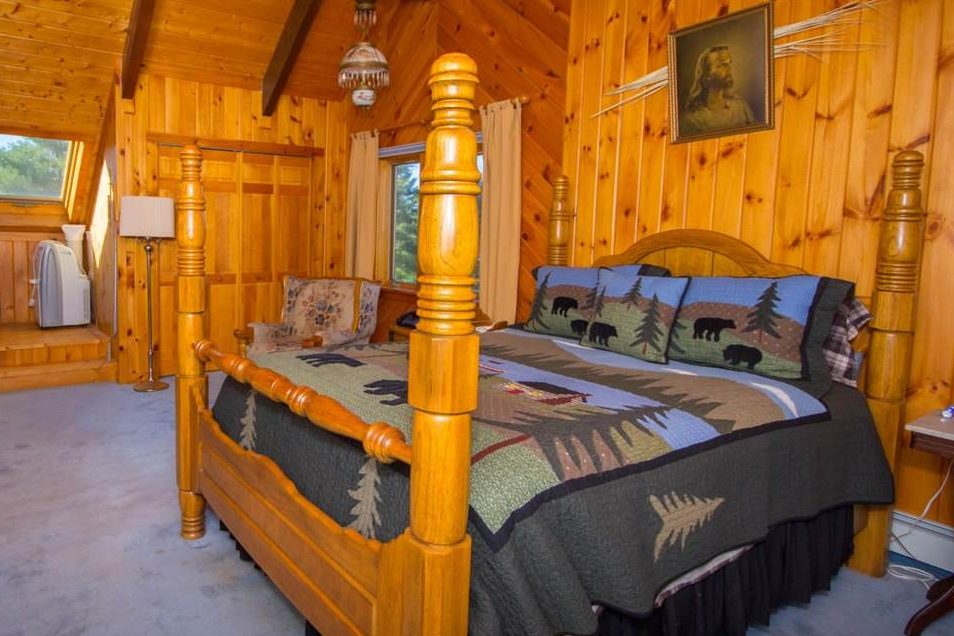 rustic bedding in pretty log home